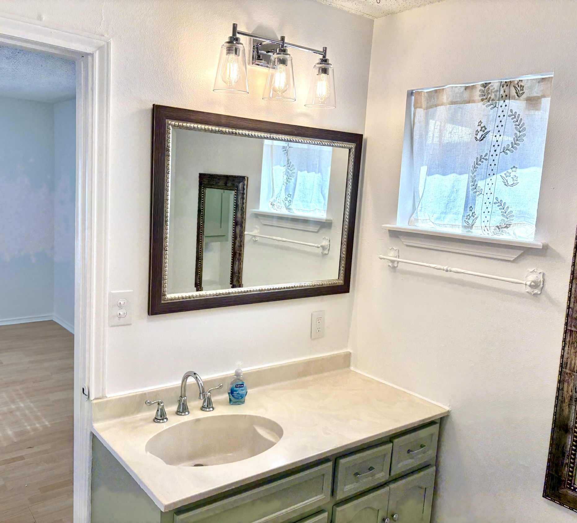Undisclosed Address Austin, TX 78721 - Photo 13 of 28 Smooth countertops and classic vanity cabinetry anchor this refreshing bathroom setting.