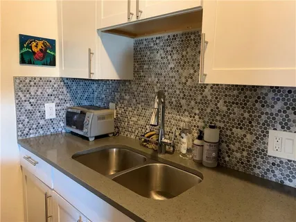 a kitchen with stainless steel appliances a refrigerator and a stove