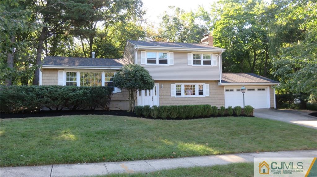 22 Perry Road East Brunswick, NJ 08816 - Photo 1 of 10 a front view of a house with a yard and trees