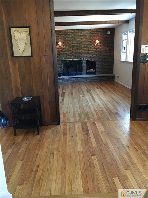 22 Perry Road East Brunswick, NJ 08816 - Photo 3 of 10 a view of a livingroom with wooden floor and a fireplace