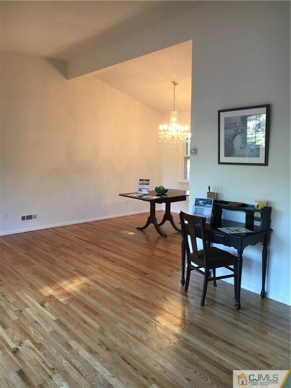 22 Perry Road East Brunswick, NJ 08816 - Photo 4 of 10 a workspace with furniture wooden floor and a window