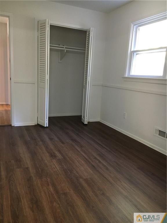 22 Perry Road East Brunswick, NJ 08816 - Photo 6 of 10 an empty room with wooden floor closet and windows