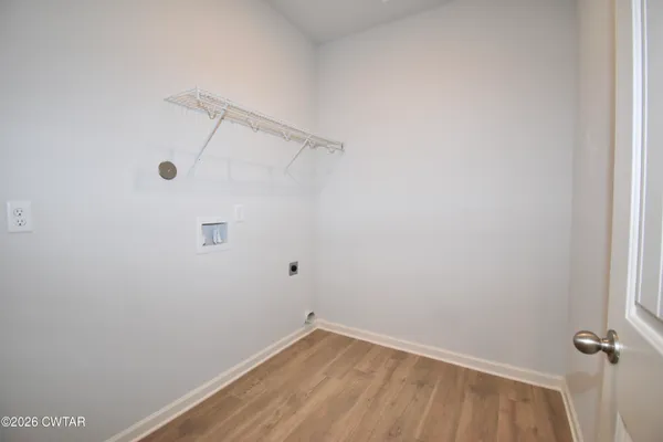 a view of a room with wooden floor