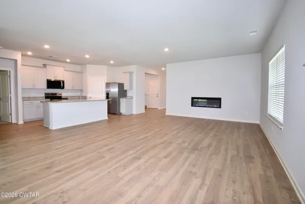 a view of kitchen with wooden floor and electronic appliances