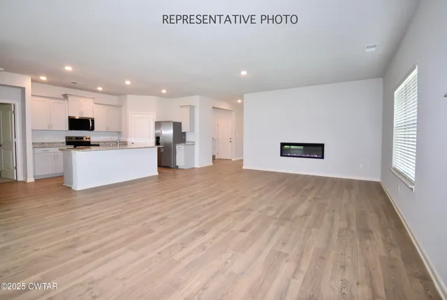a view of kitchen with wooden floor and electronic appliances