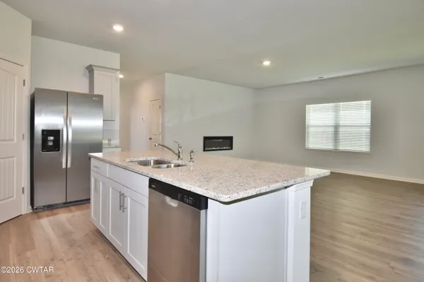 a kitchen with a sink and a refrigerator