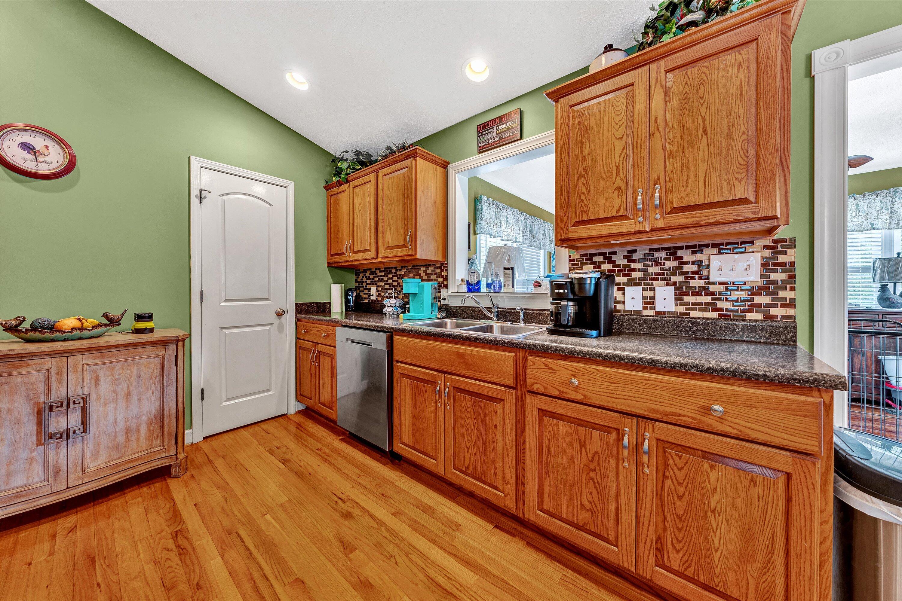 2530 Edwardsville Road Hardy, VA 24101 - Photo 10 of 30 a kitchen with granite countertop wooden cabinets a sink a window and stainless steel appliances