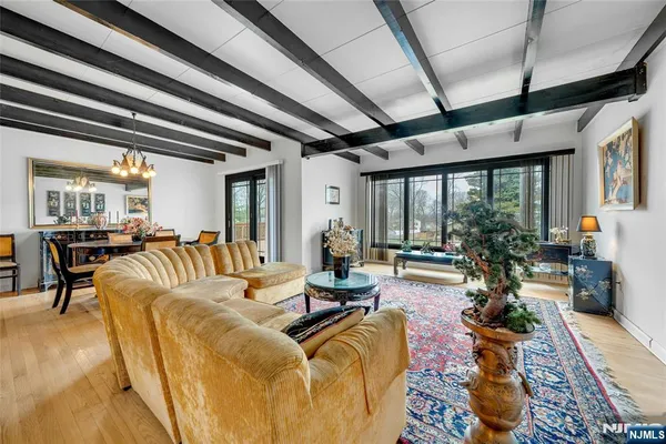 a living room with patio furniture and a large window