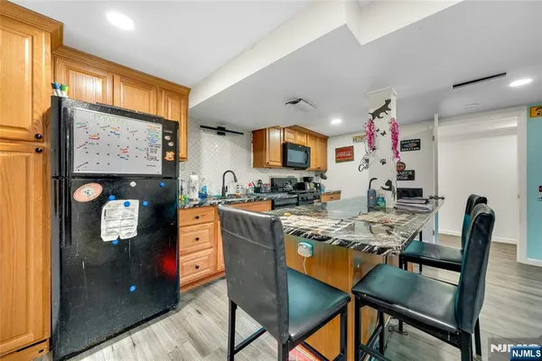 a kitchen with stainless steel appliances granite countertop a refrigerator and microwave