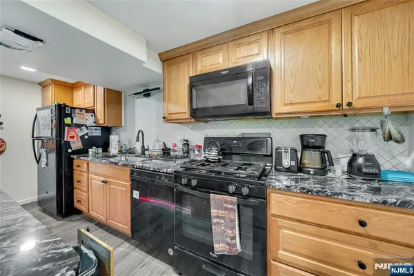 a kitchen with stainless steel appliances granite countertop a sink stove and granite counter top