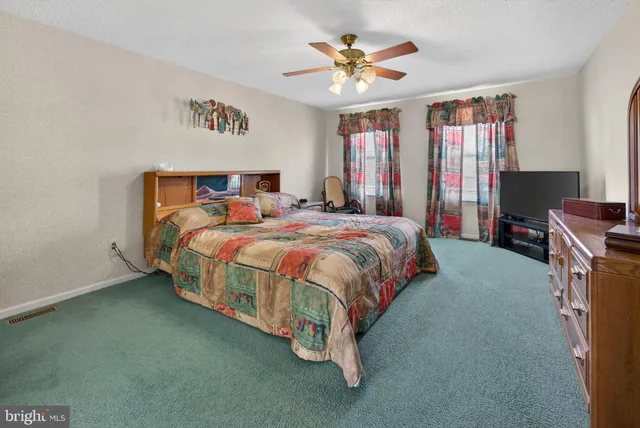 a bedroom with a bed dresser and a window