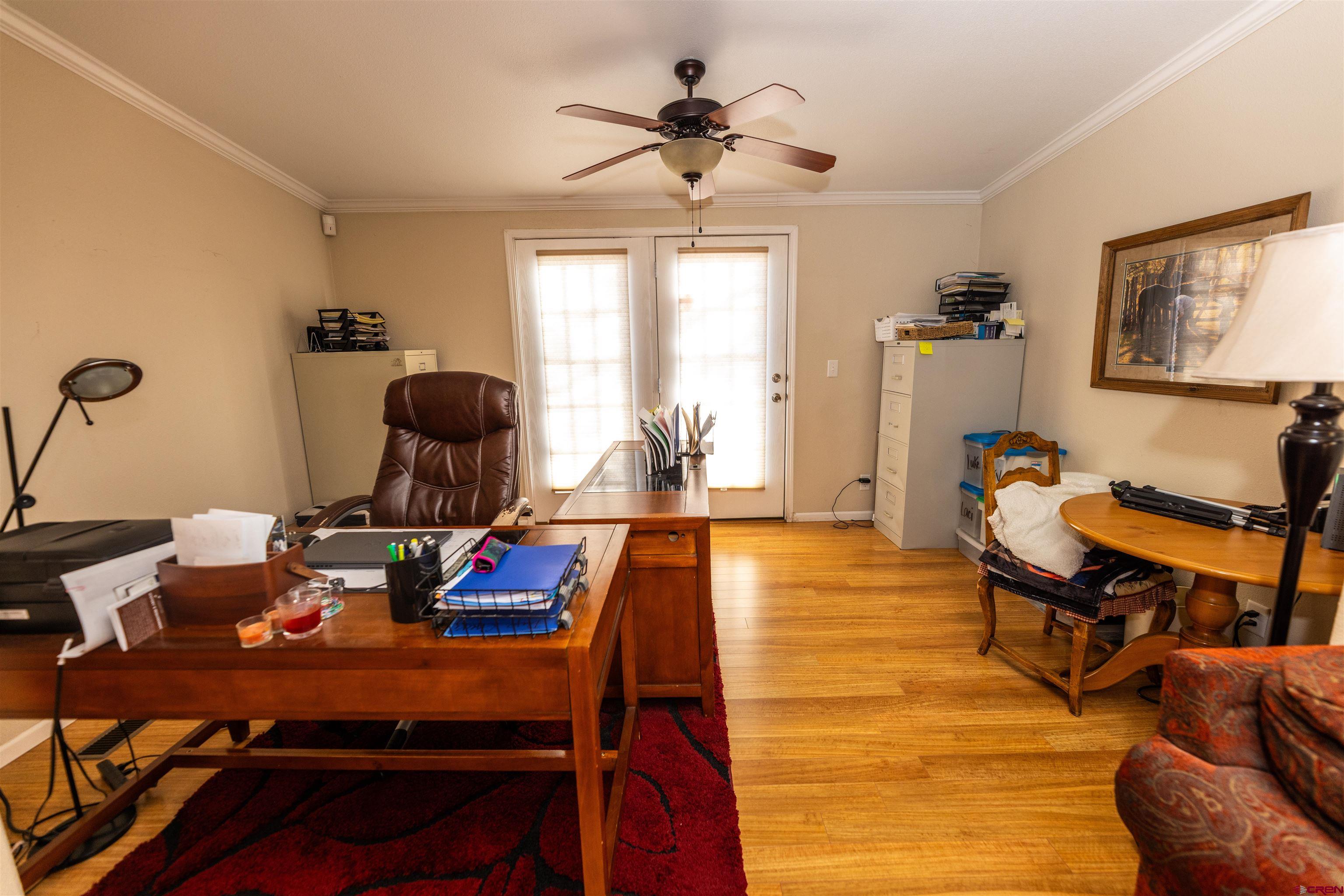 2716 Threemile Road Alamosa, CO 81101 - Photo 15 of 45 a view of a workspace with furniture and a window