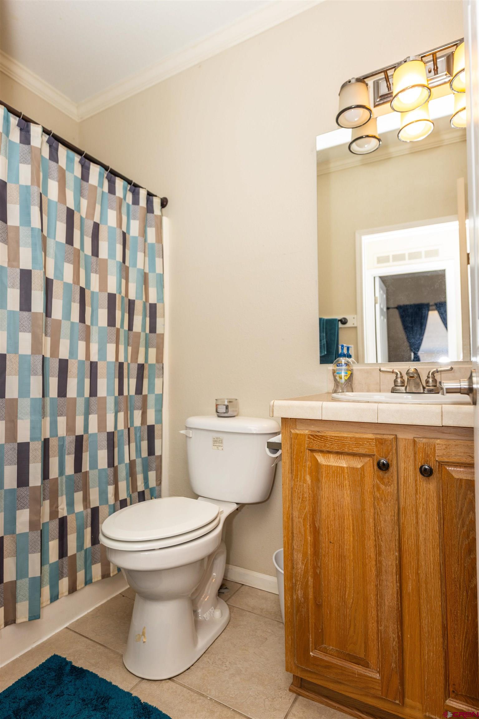 2716 Threemile Road Alamosa, CO 81101 - Photo 22 of 45 a bathroom with a double vanity sink toilet and shower