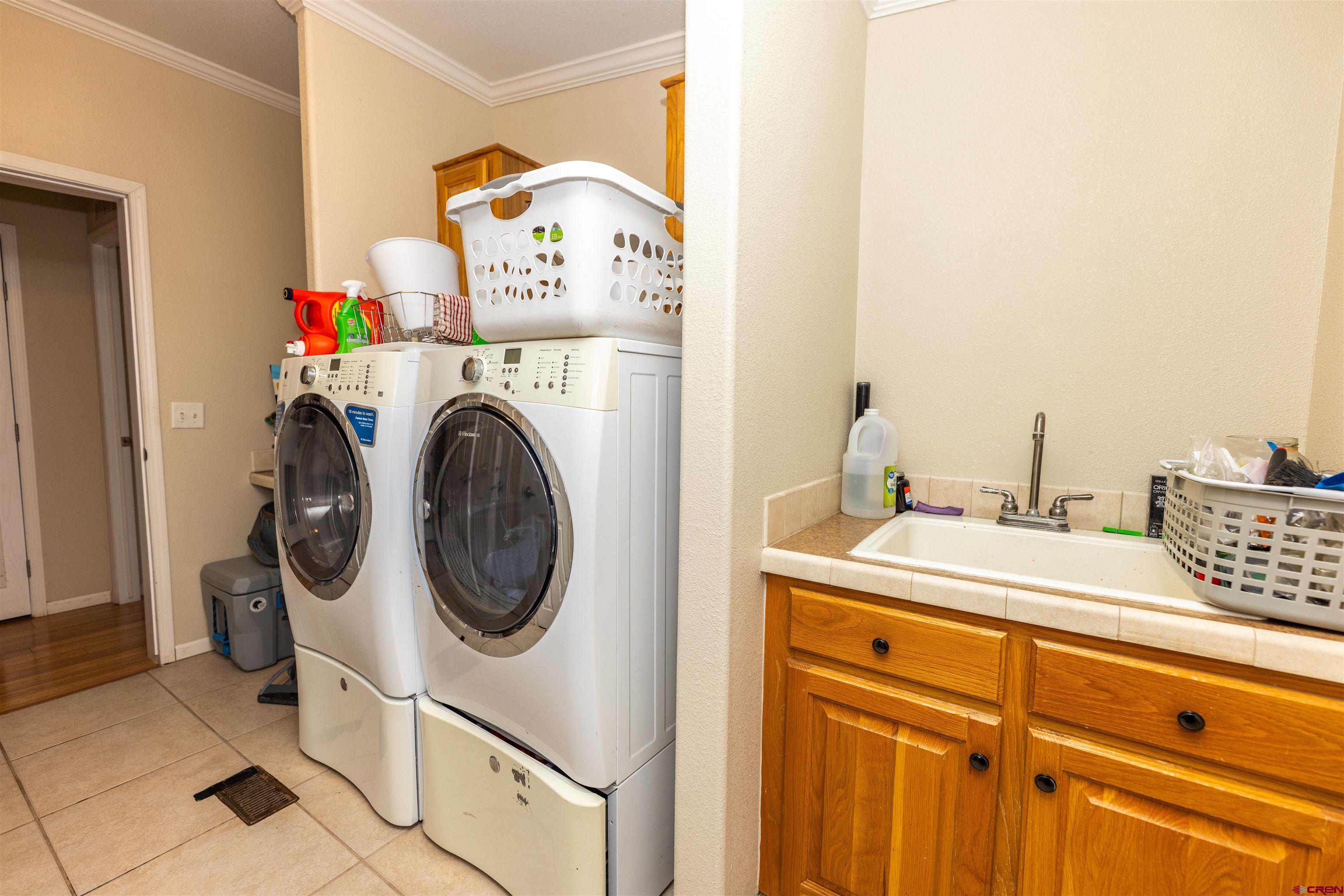 2716 Threemile Road Alamosa, CO 81101 - Photo 23 of 45 a utility room with dryer and washer