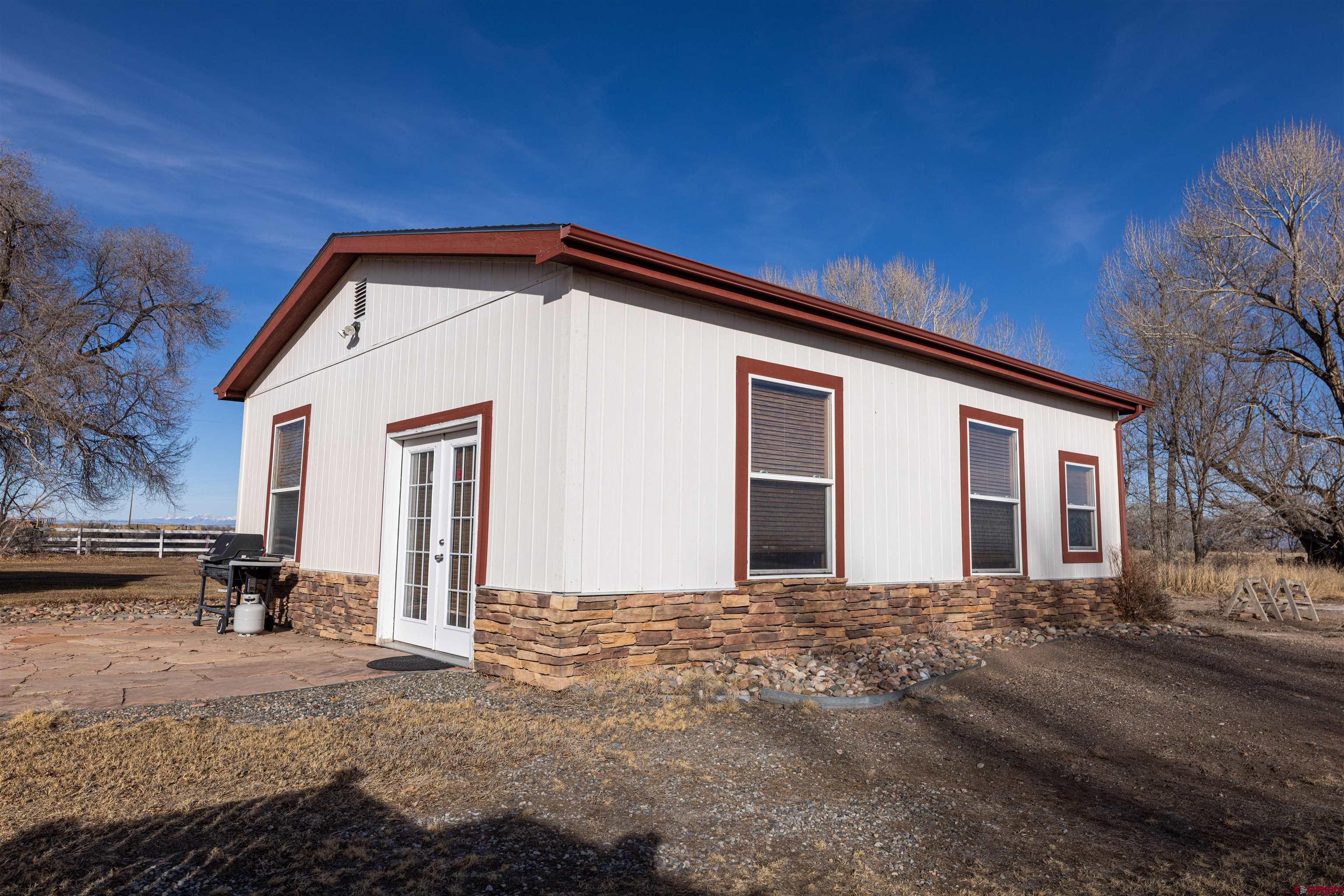 2716 Threemile Road Alamosa, CO 81101 - Photo 32 of 45 a front view of a house with a yard