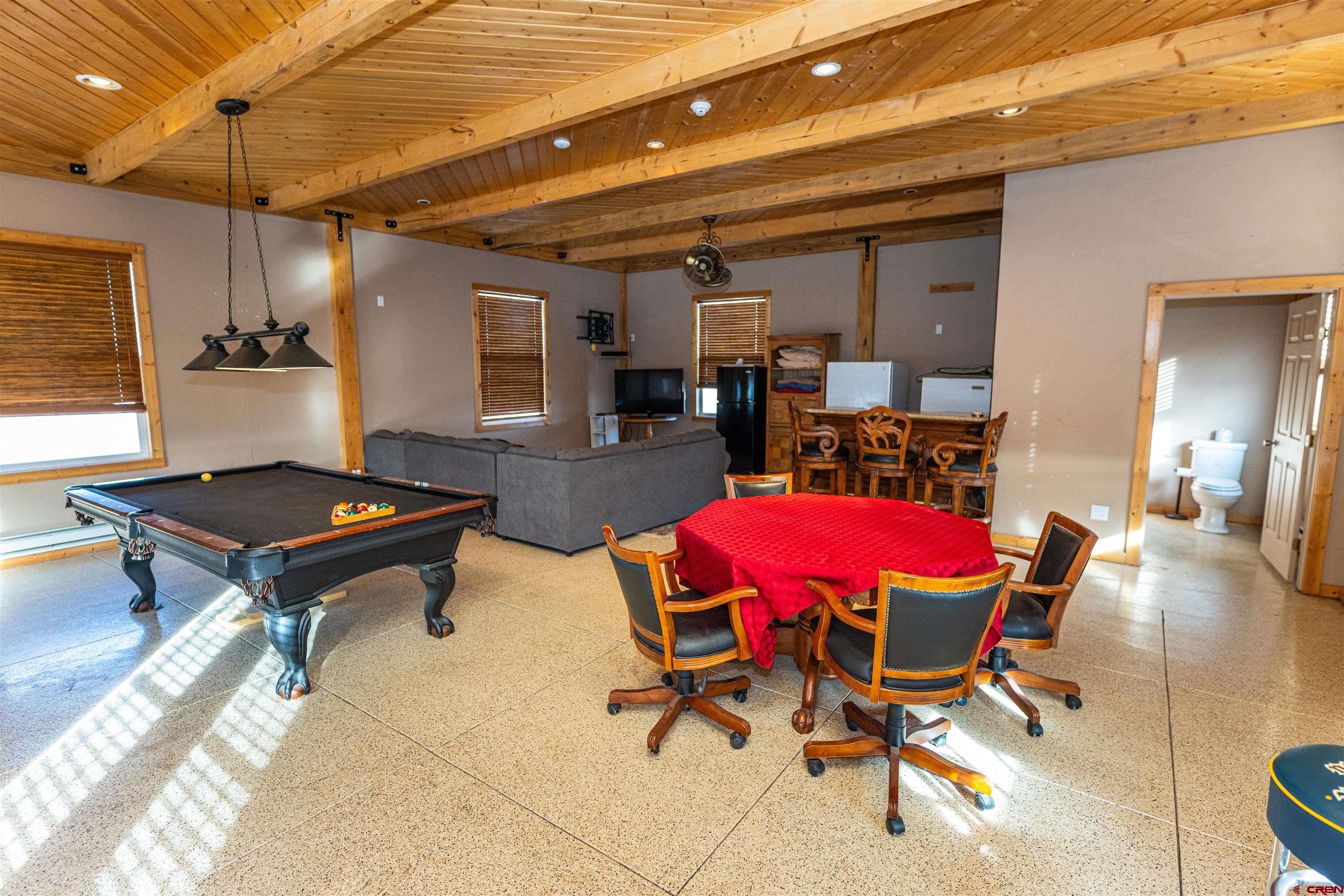 2716 Threemile Road Alamosa, CO 81101 - Photo 33 of 45 a living room with furniture a table and chairs