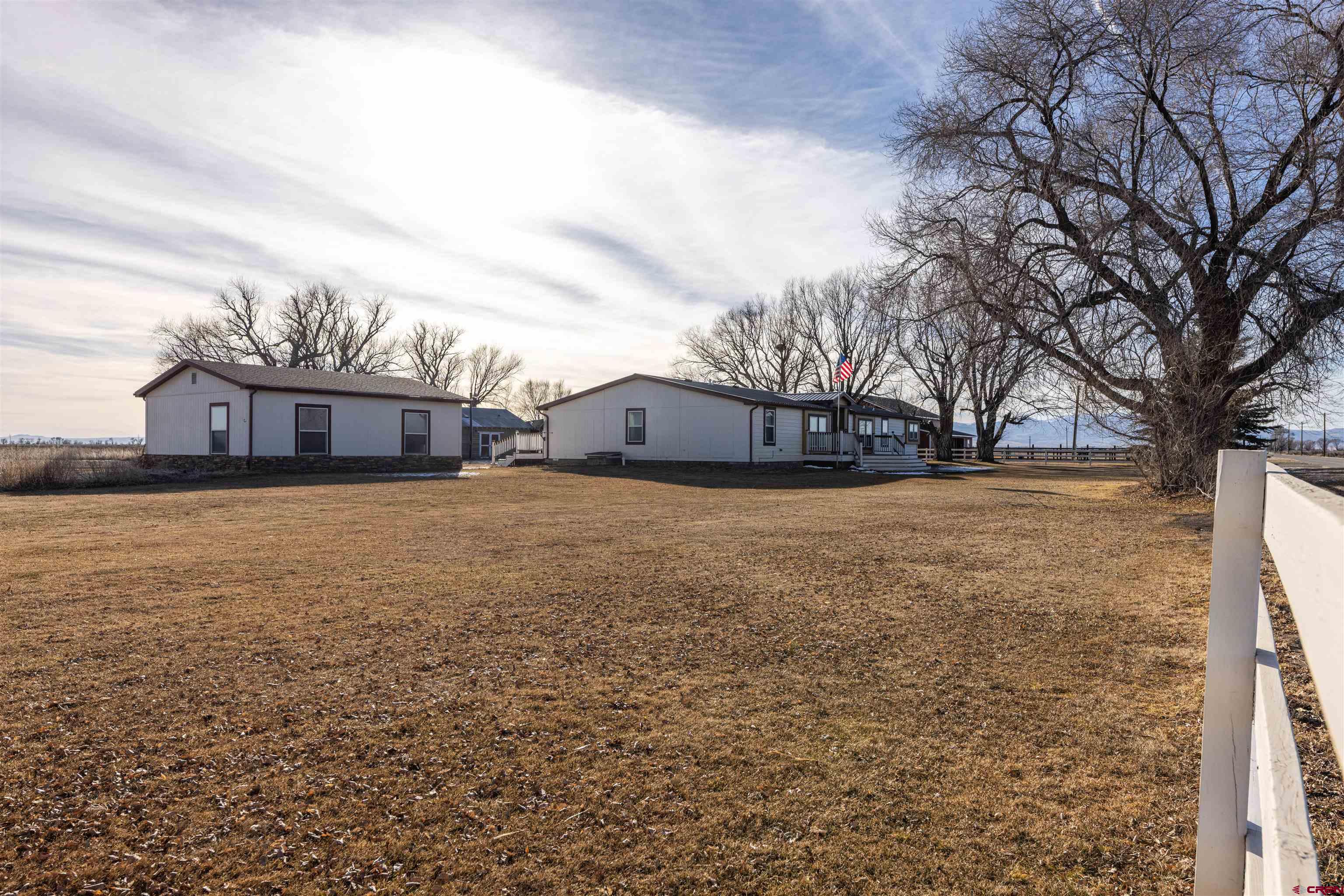 2716 Threemile Road Alamosa, CO 81101 - Photo 36 of 45 a view of house with yard and car parked