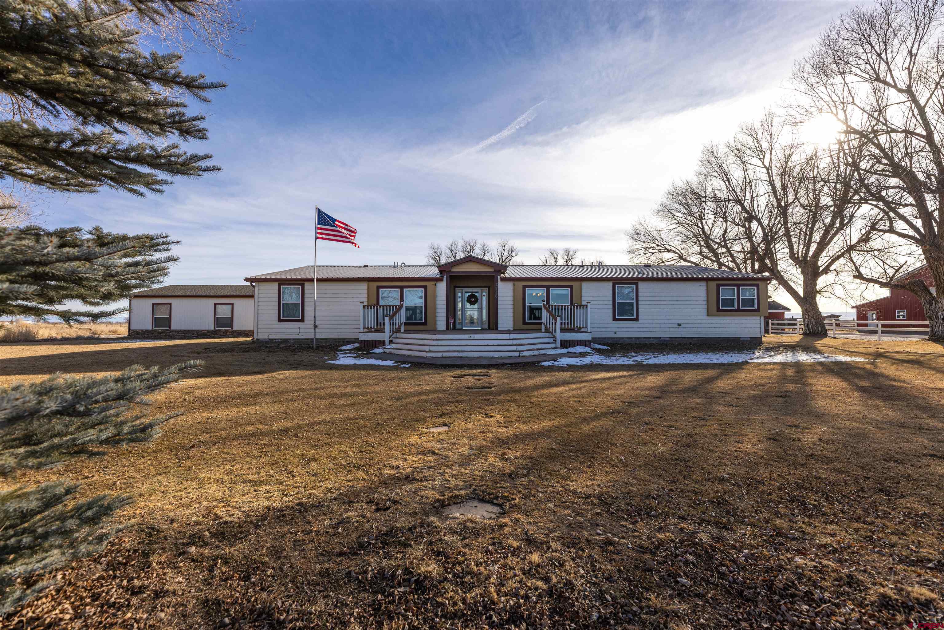 2716 Threemile Road Alamosa, CO 81101 - Photo 37 of 45 a front view of a house with a garden