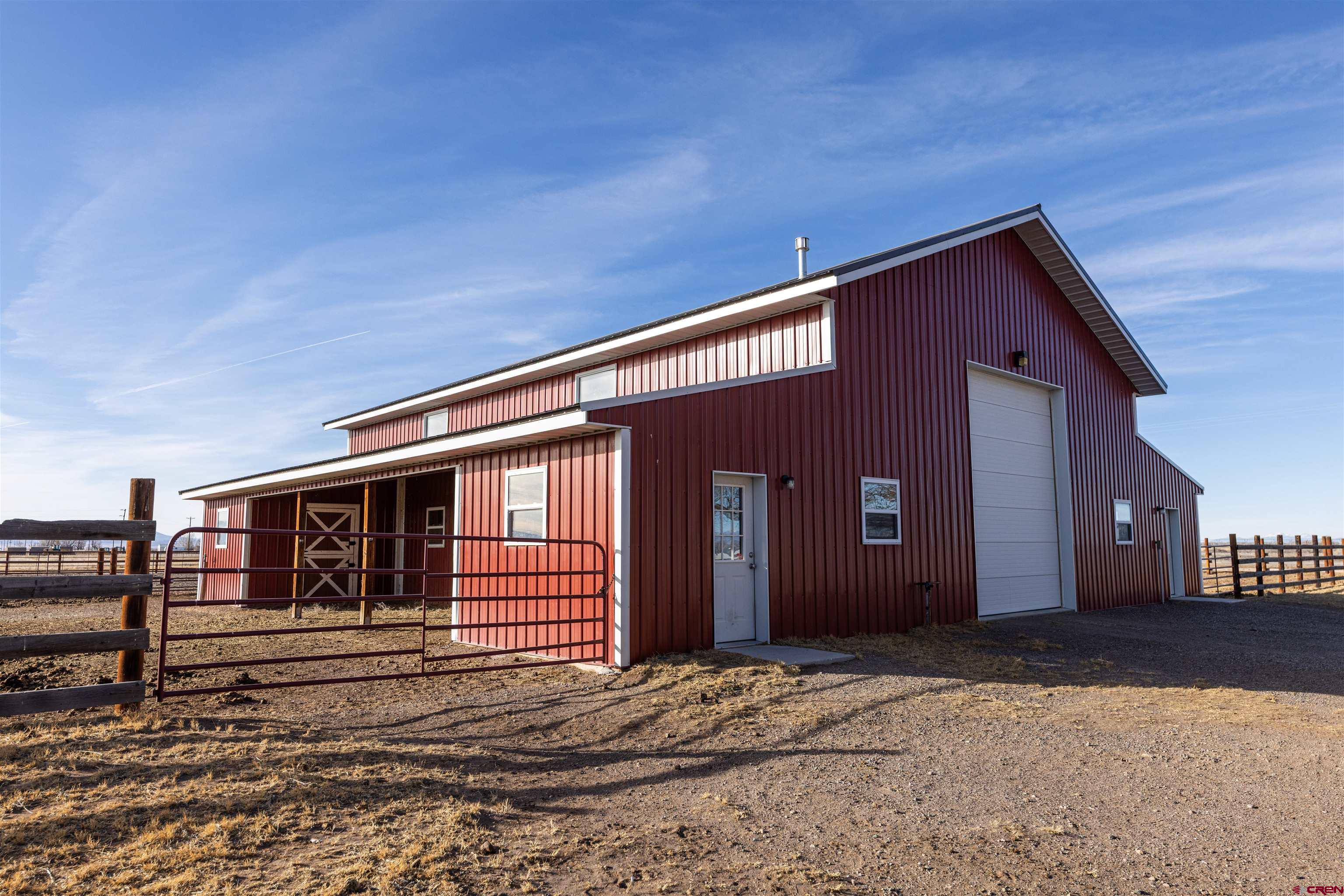 2716 Threemile Road Alamosa, CO 81101 - Photo 38 of 45 a front view of a house with a garage