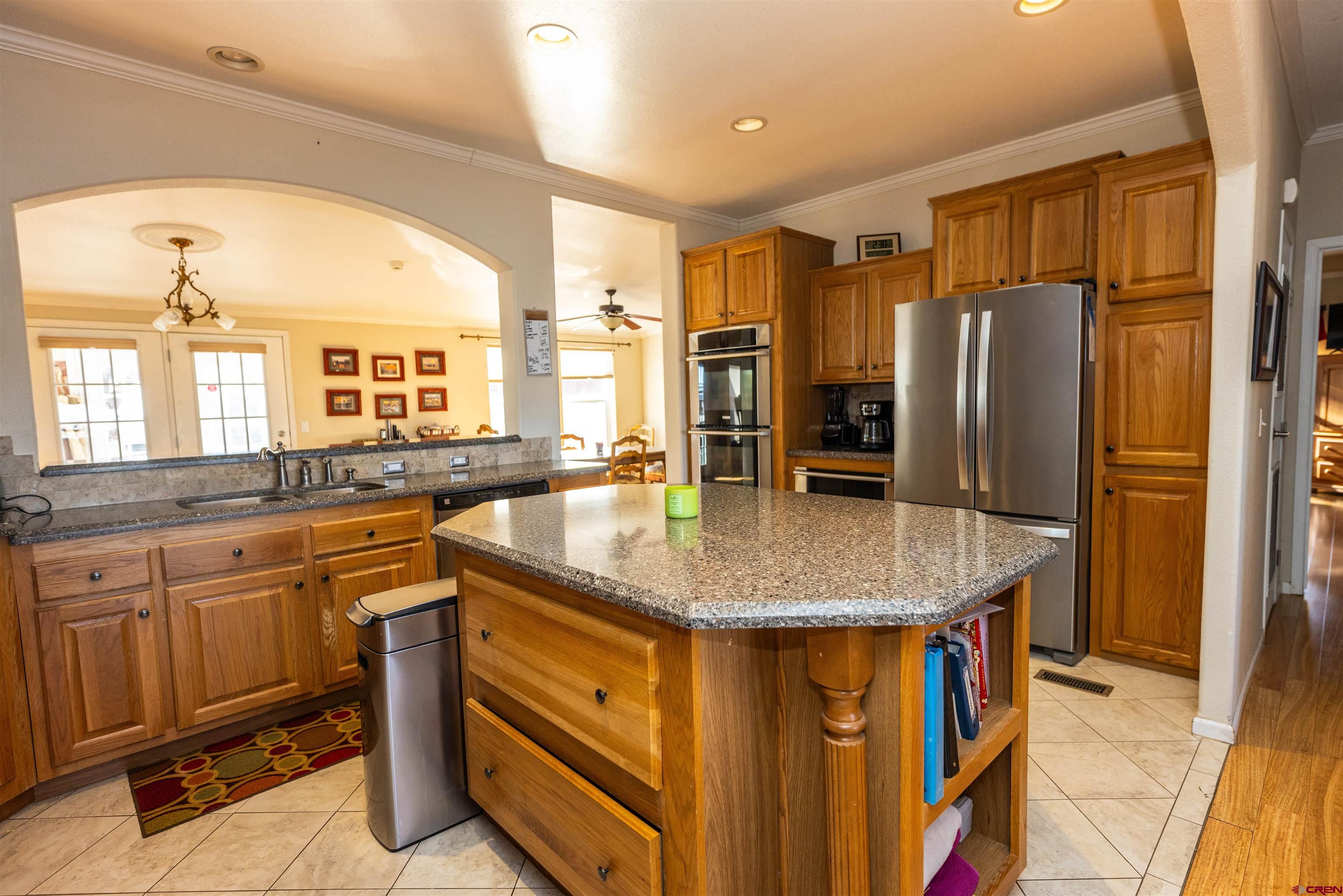 2716 Threemile Road Alamosa, CO 81101 - Photo 7 of 45 a kitchen with stainless steel appliances granite countertop a sink and refrigerator