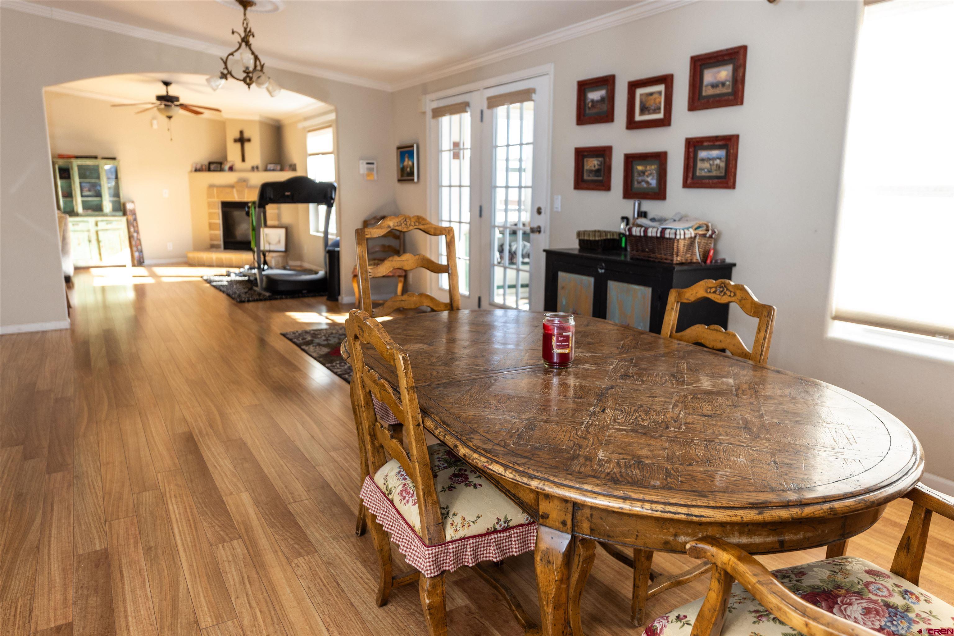 2716 Threemile Road Alamosa, CO 81101 - Photo 9 of 45 a dining room with wooden floor table and chairs