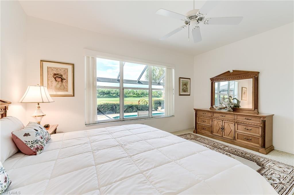 9156 Spring Run Boulevard Estero, FL 34135 - Photo 13 of 34 a bedroom with a bed and a dresser