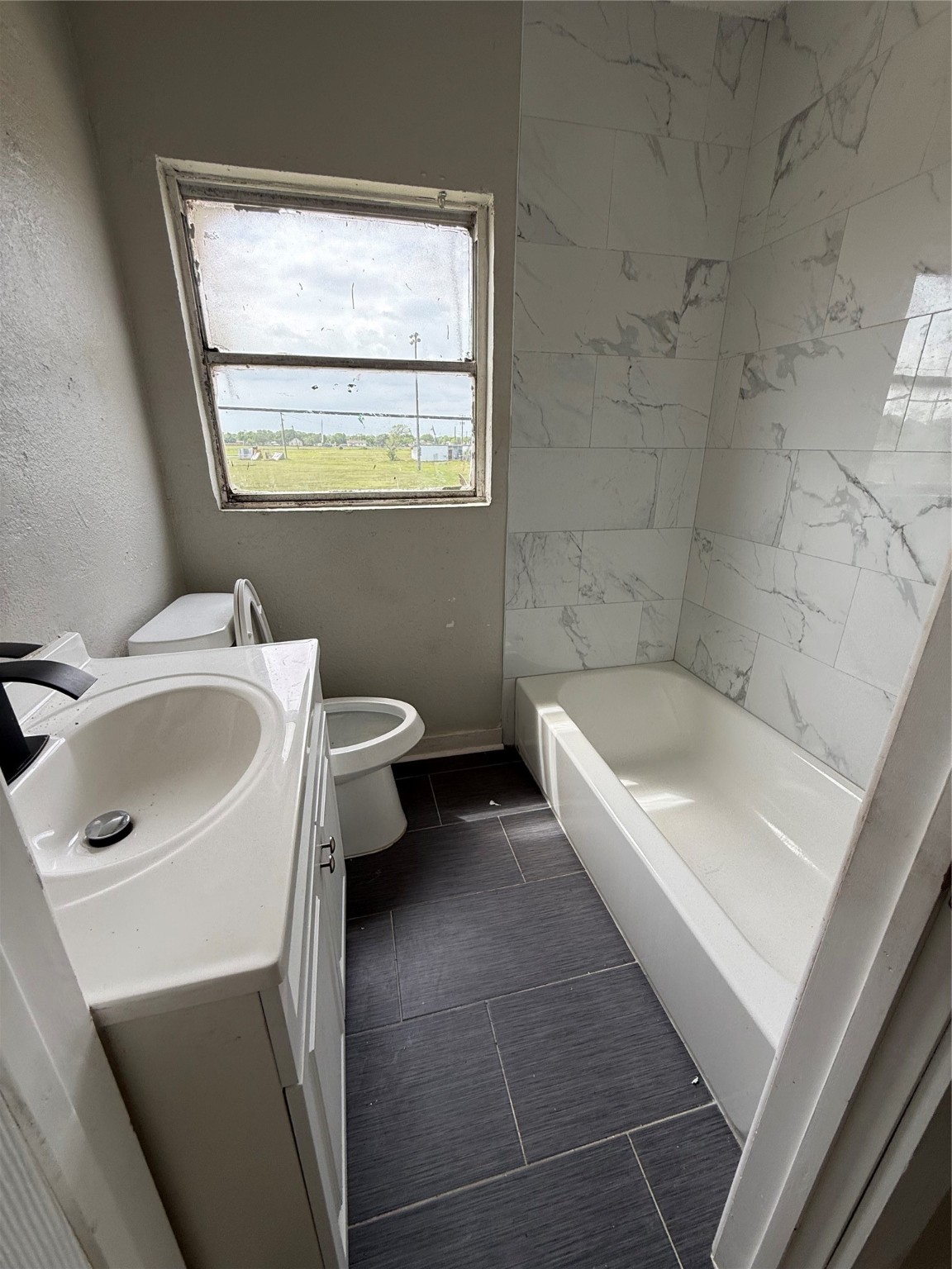 126 West 6th Street, Unit 3 Freeport, TX 77541 - Photo 6 of 6 a bathroom with a sink a toilet and shower