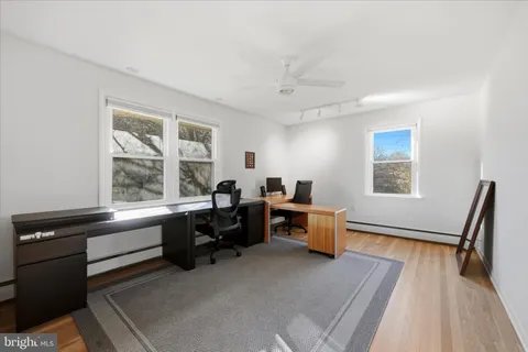 a view of a workspace with furniture and a window