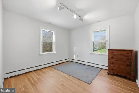 an empty room with windows and closet