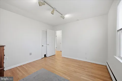 a view of a room with wooden floor