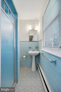a bathroom with a sink toilet and mirror