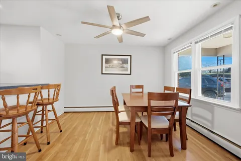 a view of a dining room with furniture and wooden floor