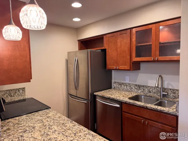 a kitchen with a refrigerator and a sink