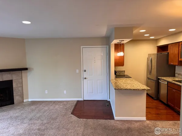 a view of kitchen cabinets kitchen island wooden floor center island and stainless steel appliances