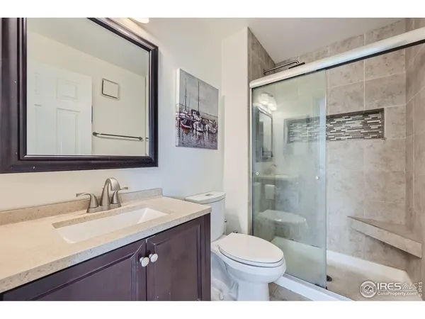 a bathroom with a sink a toilet a shower and a mirror