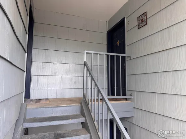 a yellow house with lots of trees in front of it