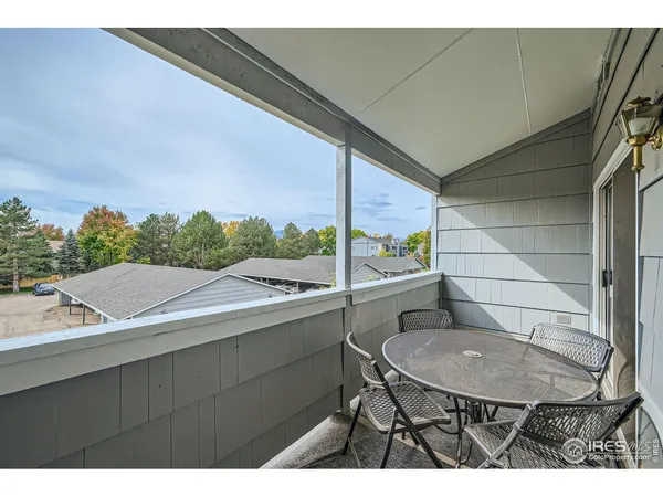 a balcony with table and chairs