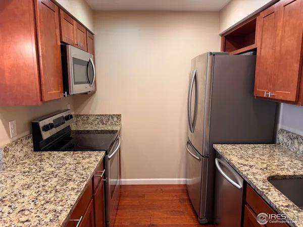 a kitchen with stainless steel appliances granite countertop a refrigerator stove and oven