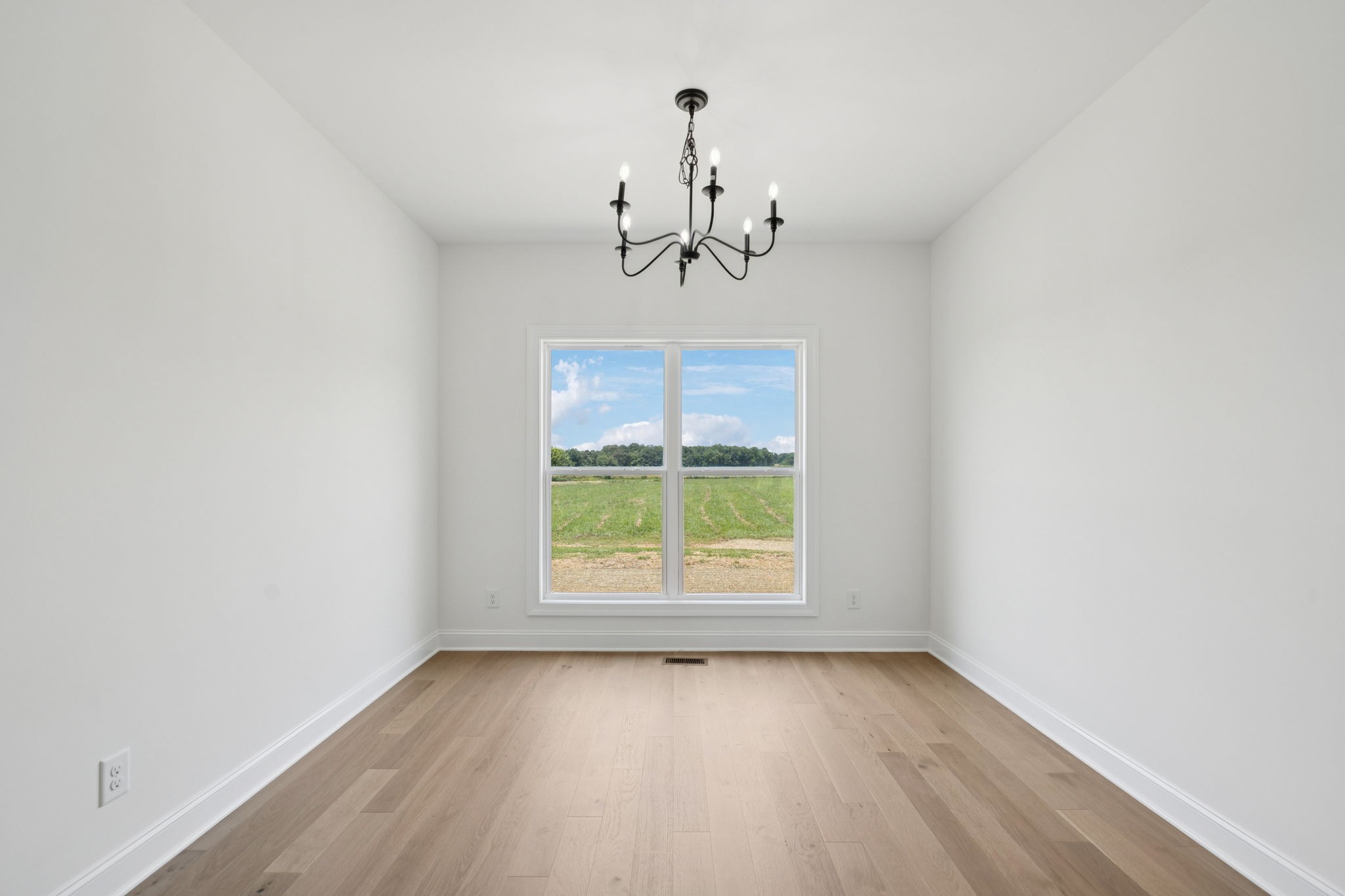 0 Midland Road Bell Buckle, TN 37020 - Photo 19 of 36 an empty room with a window and a chandelier fan