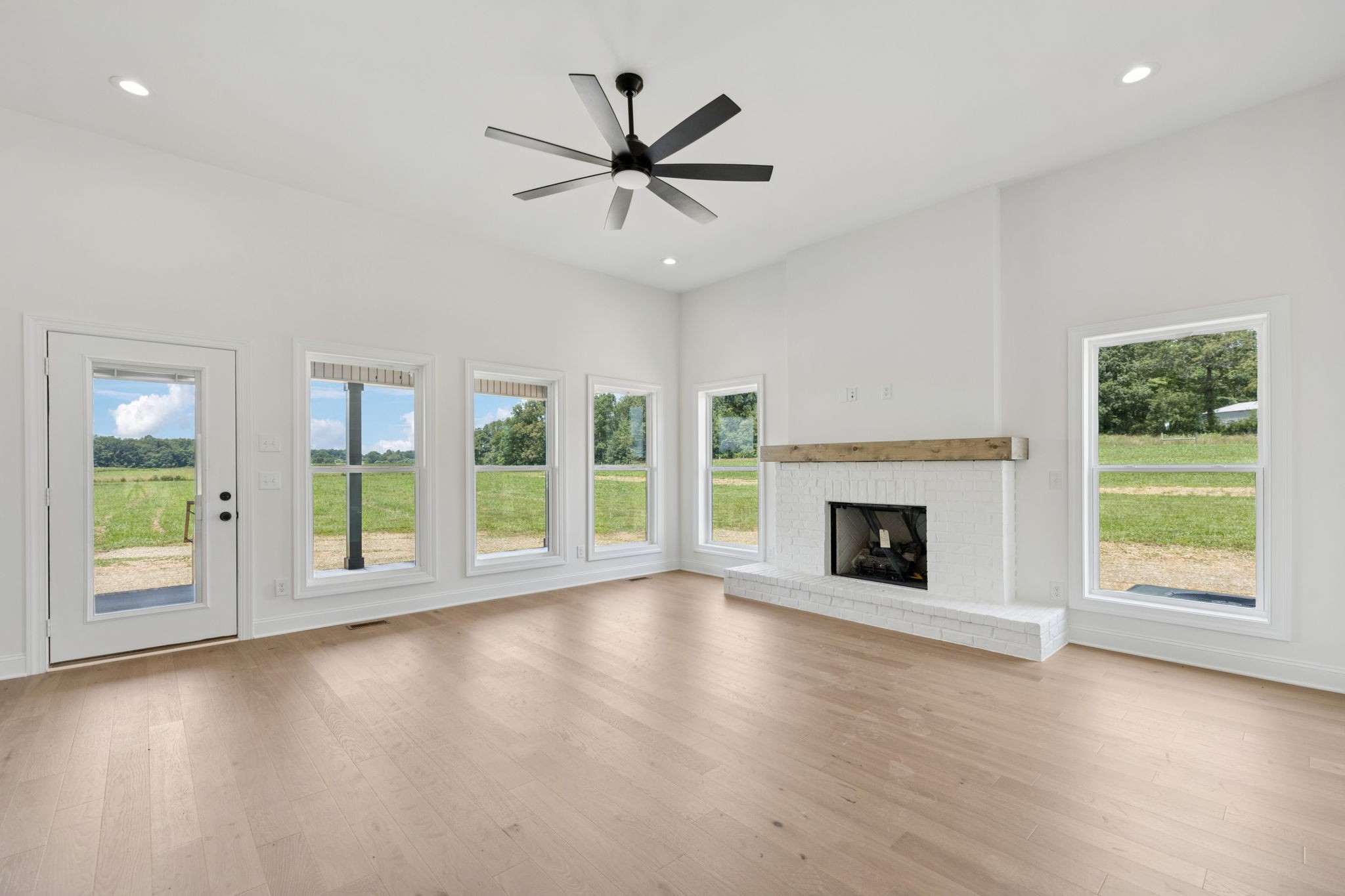 0 Midland Road Bell Buckle, TN 37020 - Photo 7 of 36 an empty room with windows fireplace and wooden floor
