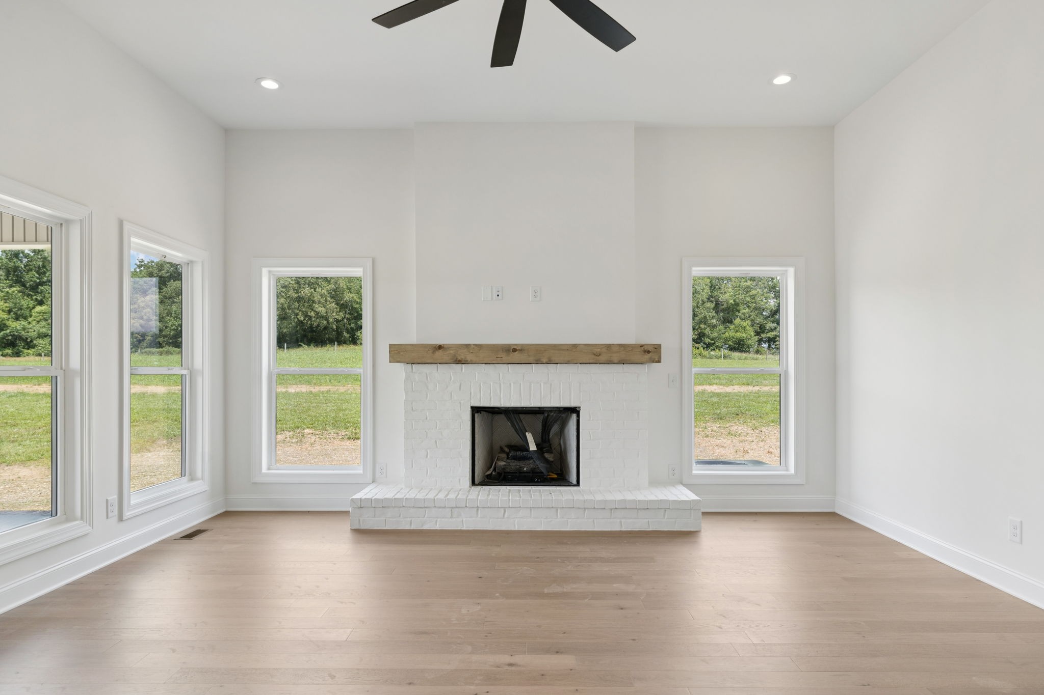 0 Midland Road Bell Buckle, TN 37020 - Photo 8 of 36 an empty room with windows fireplace and wooden floor