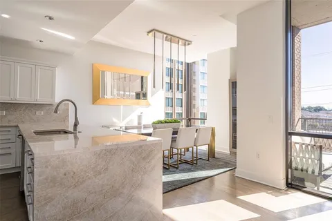 a large kitchen with sink and cabinets