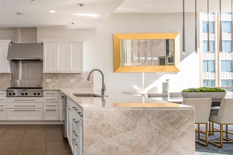 a kitchen with a stove a sink and a cabinets