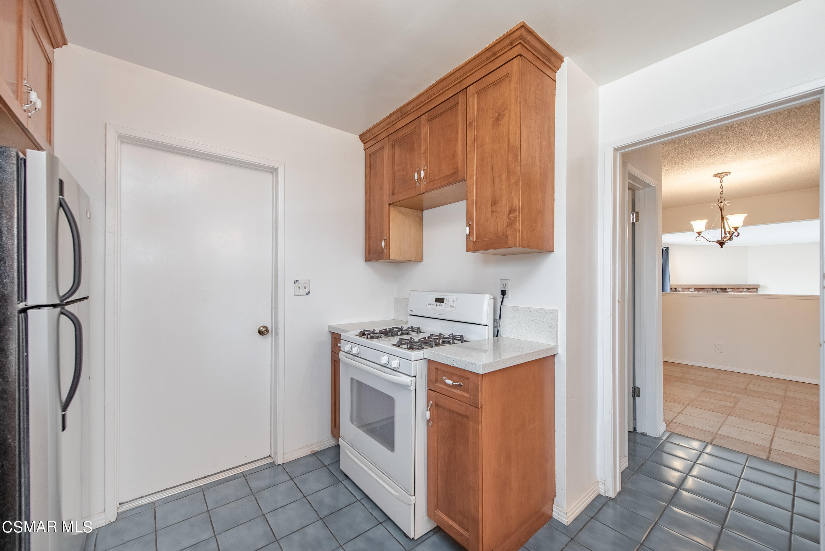 1858 Sutter Avenue Simi Valley, CA 93065 - Photo 11 of 24 a kitchen with a stove top oven a sink and a refrigerator