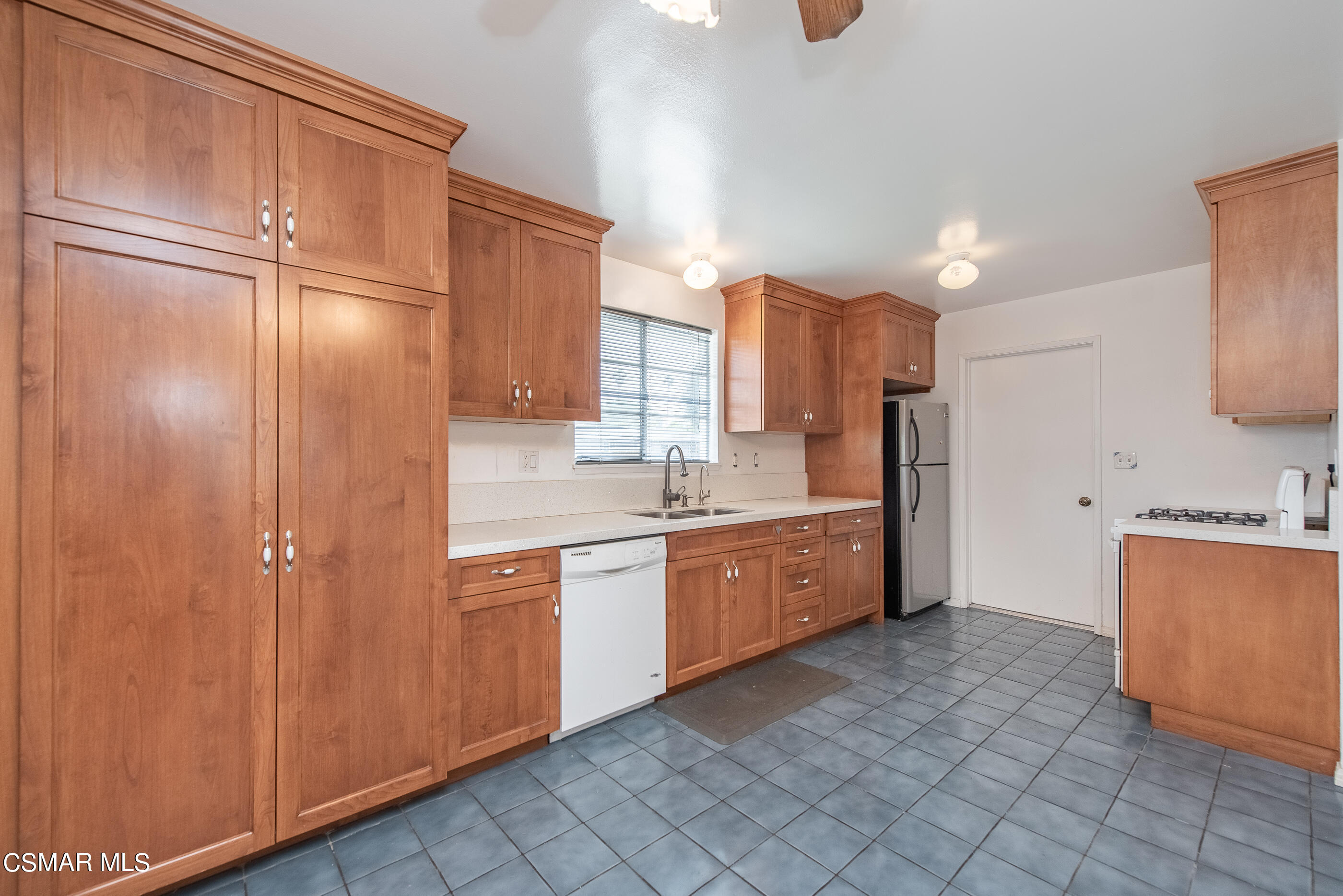 1858 Sutter Avenue Simi Valley, CA 93065 - Photo 14 of 24 a large kitchen with stainless steel appliances granite countertop a refrigerator and a sink