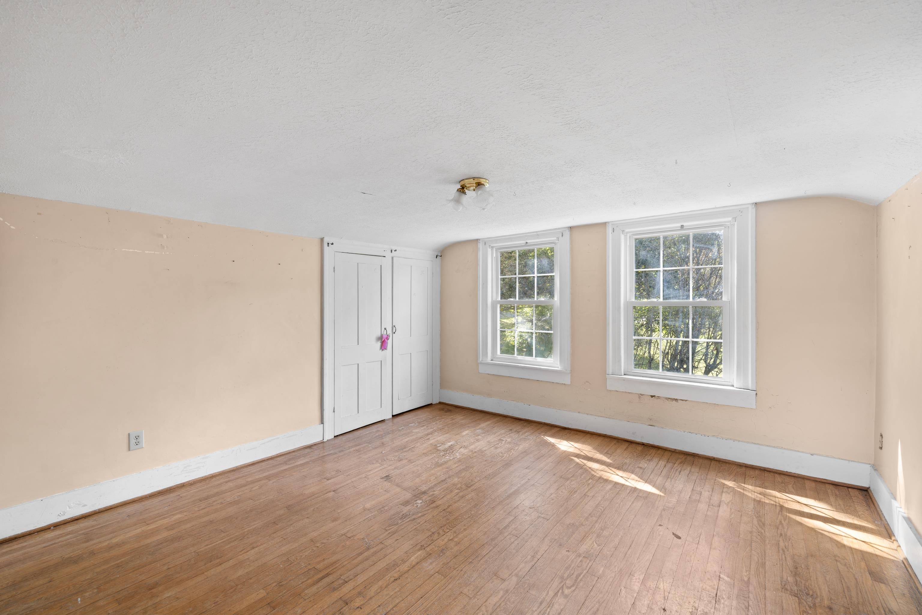 146 Mish Barn Road Middlebrook, VA 24459 - Photo 28 of 54 an empty room with wooden floor and windows