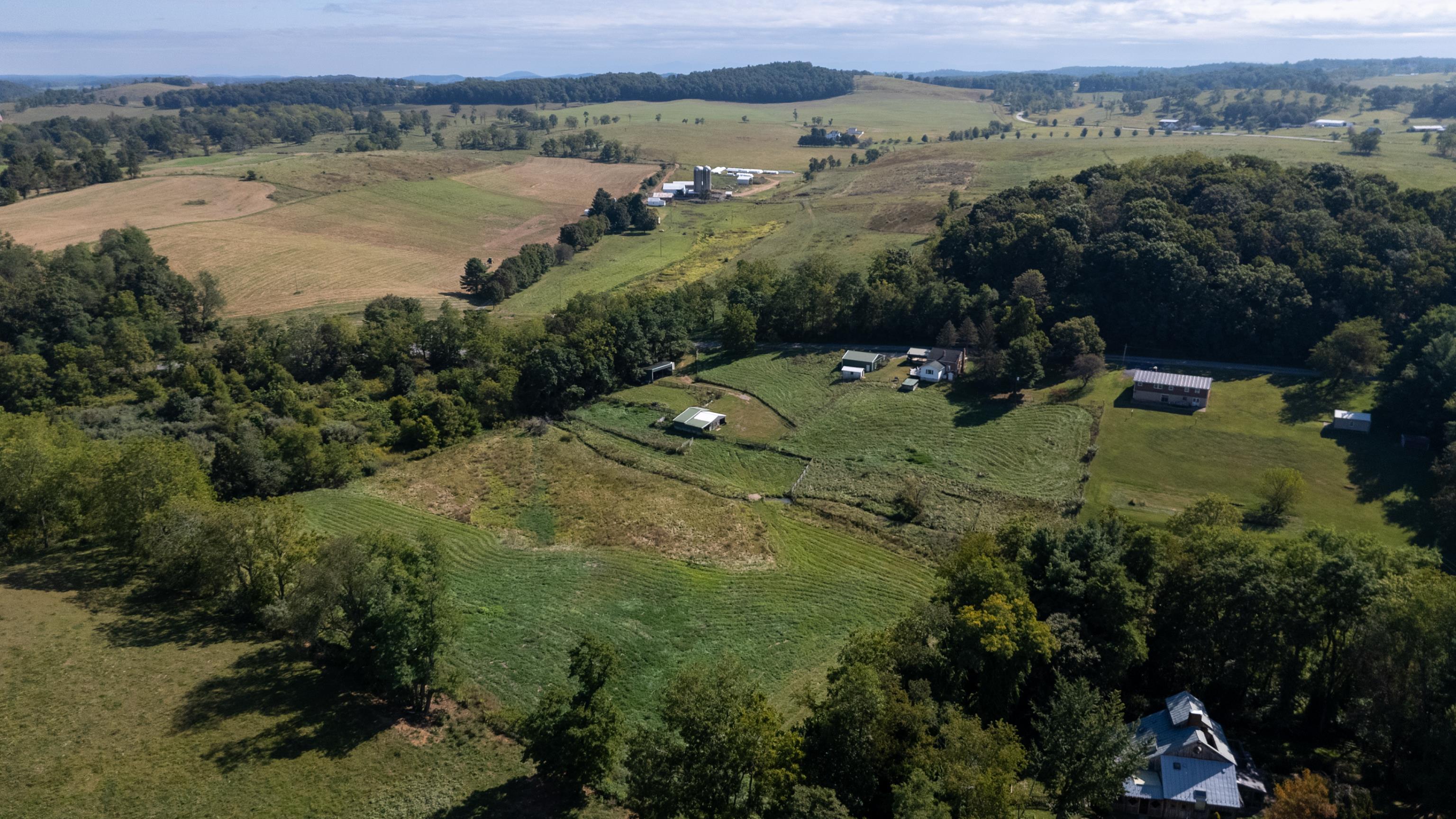 146 Mish Barn Road Middlebrook, VA 24459 - Photo 51 of 54 an aerial view of green landscape with trees houses and mountain view