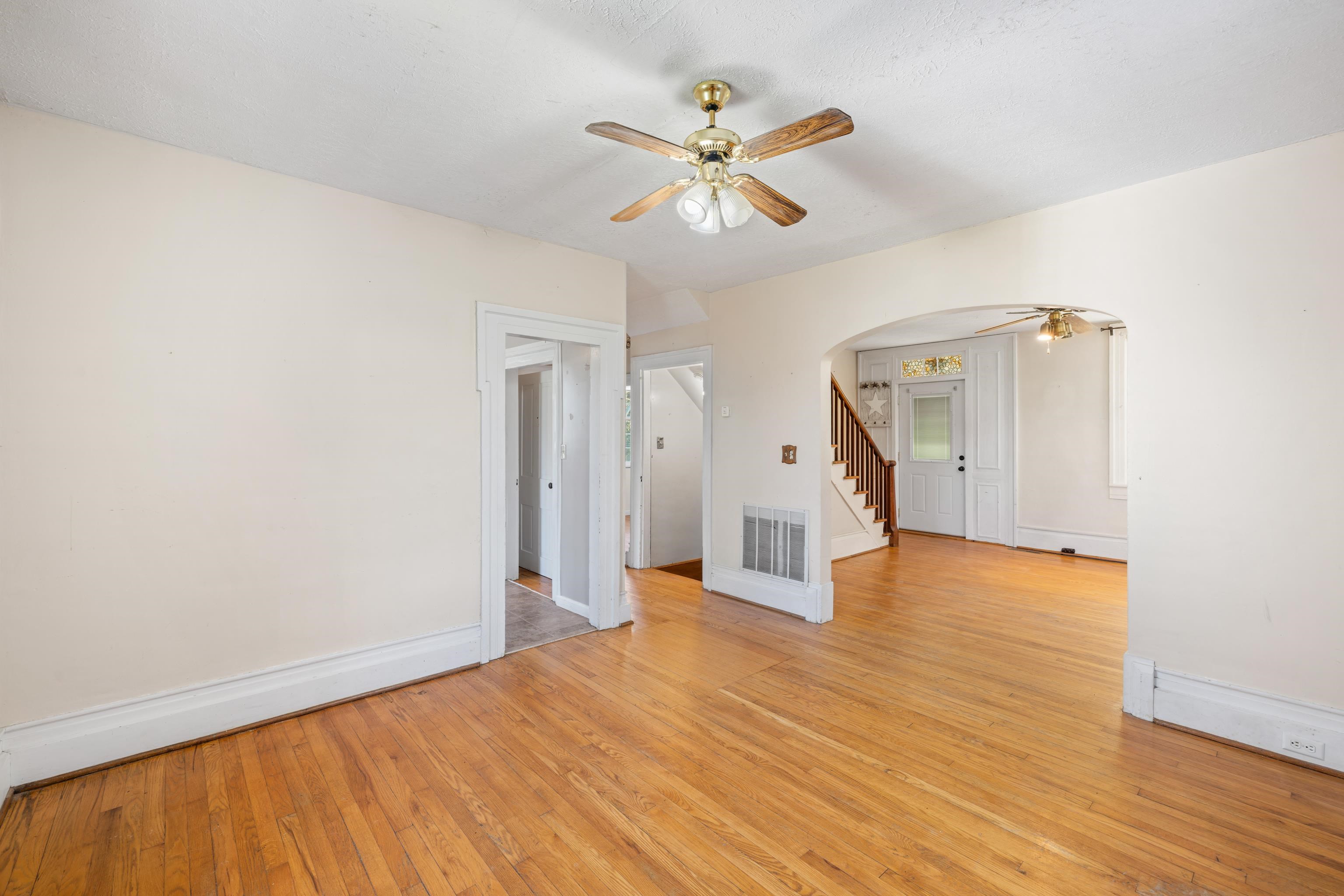 146 Mish Barn Road Middlebrook, VA 24459 - Photo 9 of 54 a view of a livingroom with wooden floor and a ceiling fan