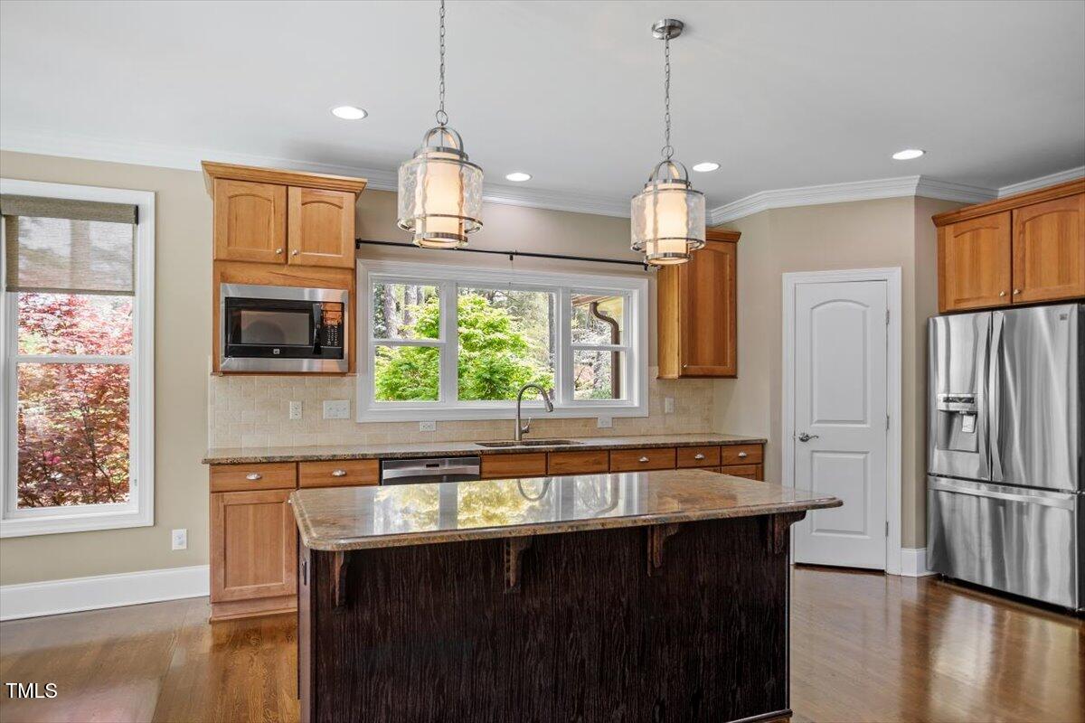 1422 Gormly Circle Sanford, NC 27330 - Photo 13 of 59 a kitchen with stainless steel appliances a sink stove and refrigerator