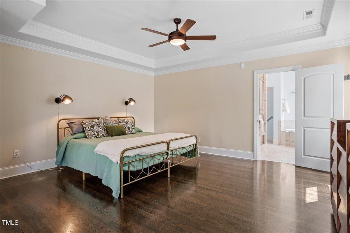 1422 Gormly Circle Sanford, NC 27330 - Photo 17 of 59 a bedroom with a bed and a table with wooden floor